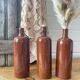 Old hot water bottles in glazed sandstone