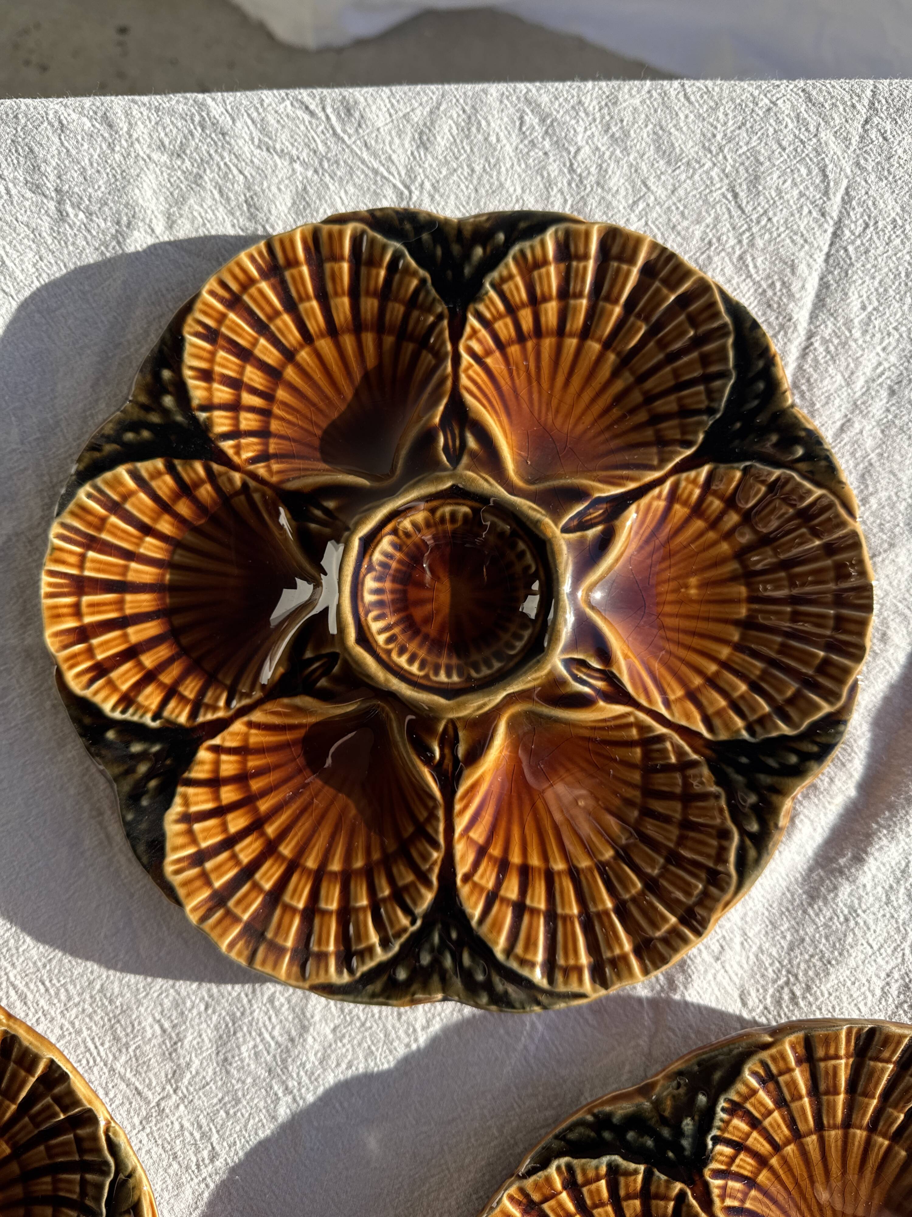 Set of 12 oyster or shell plates in glazed brown ceramic D