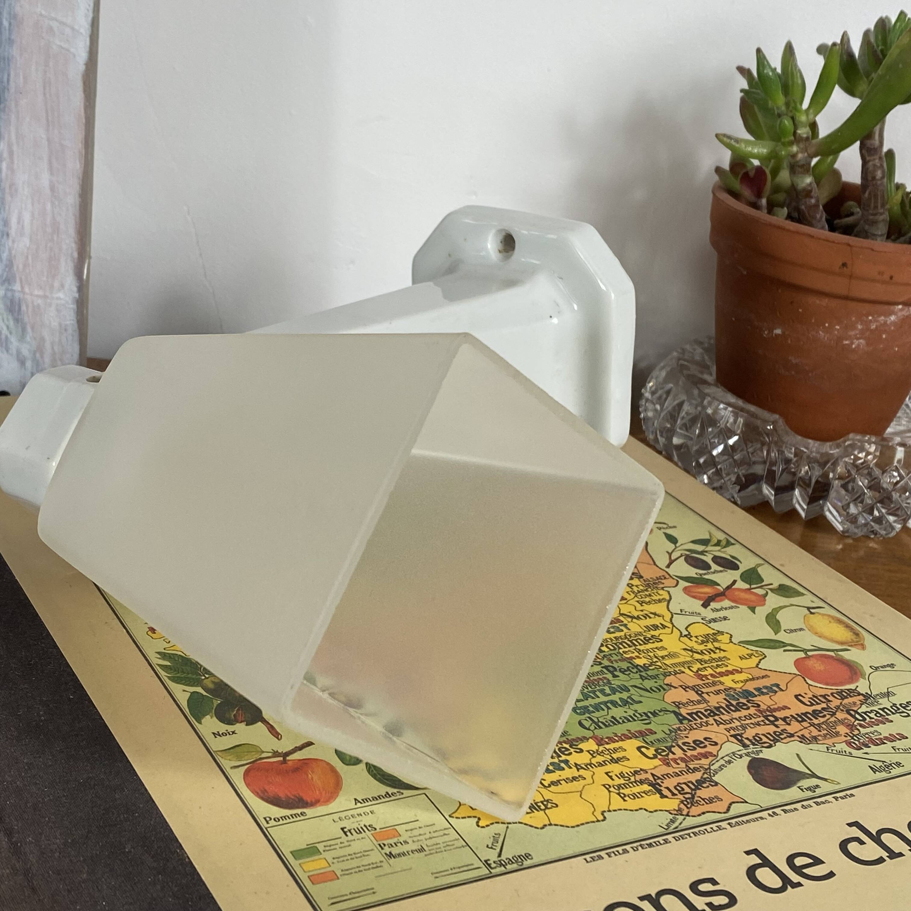 Swan neck wall light in ceramic with a translucent glass globe.