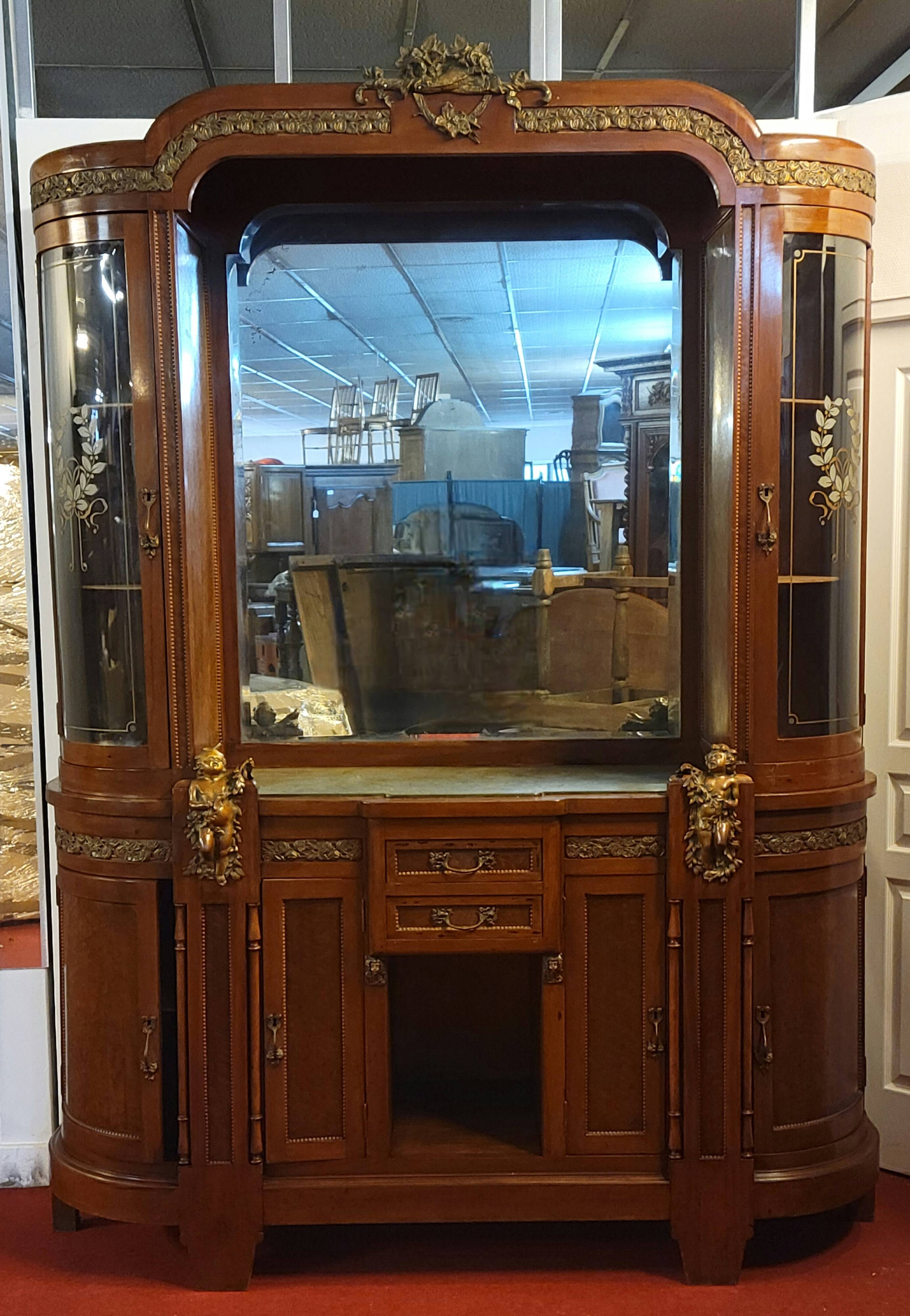 Empire style half-moon shaped mahogany bookcase with putti