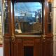Empire style half-moon shaped mahogany bookcase with putti