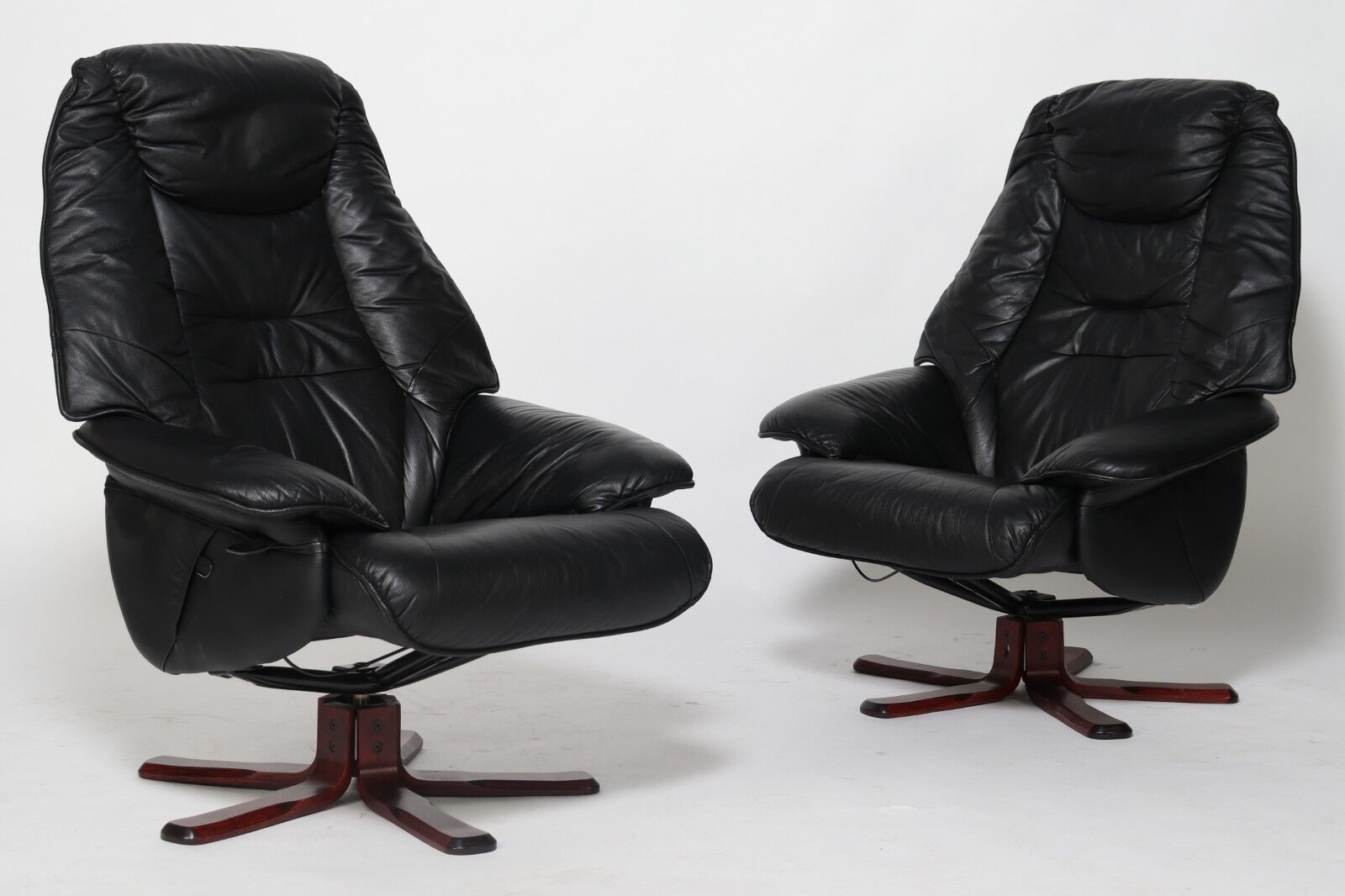 Pair of Danish black leather recliner swivel chairs by Hjort Knudsen