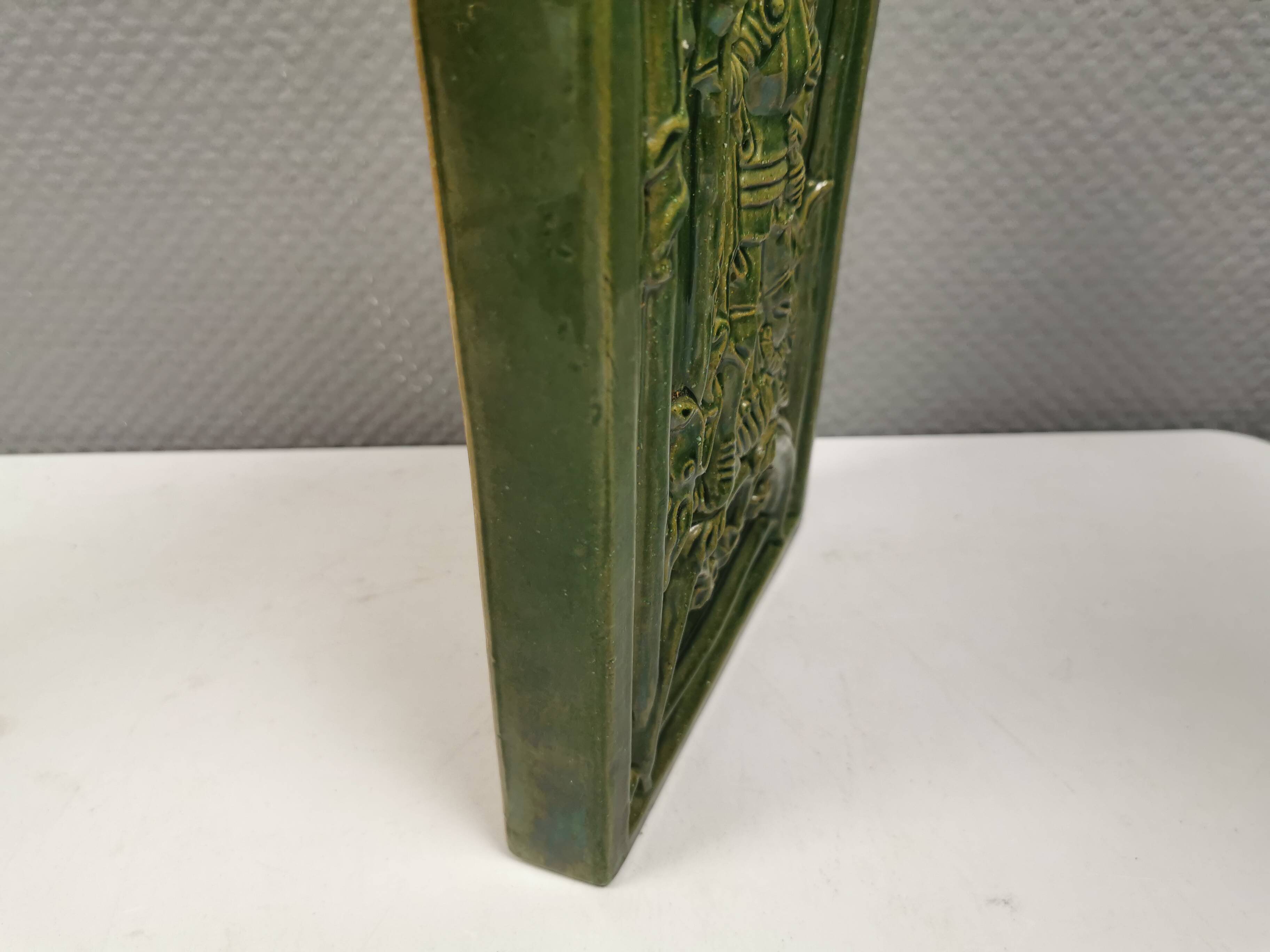 Antique tile in green faience, motif of Saint George and the dragon