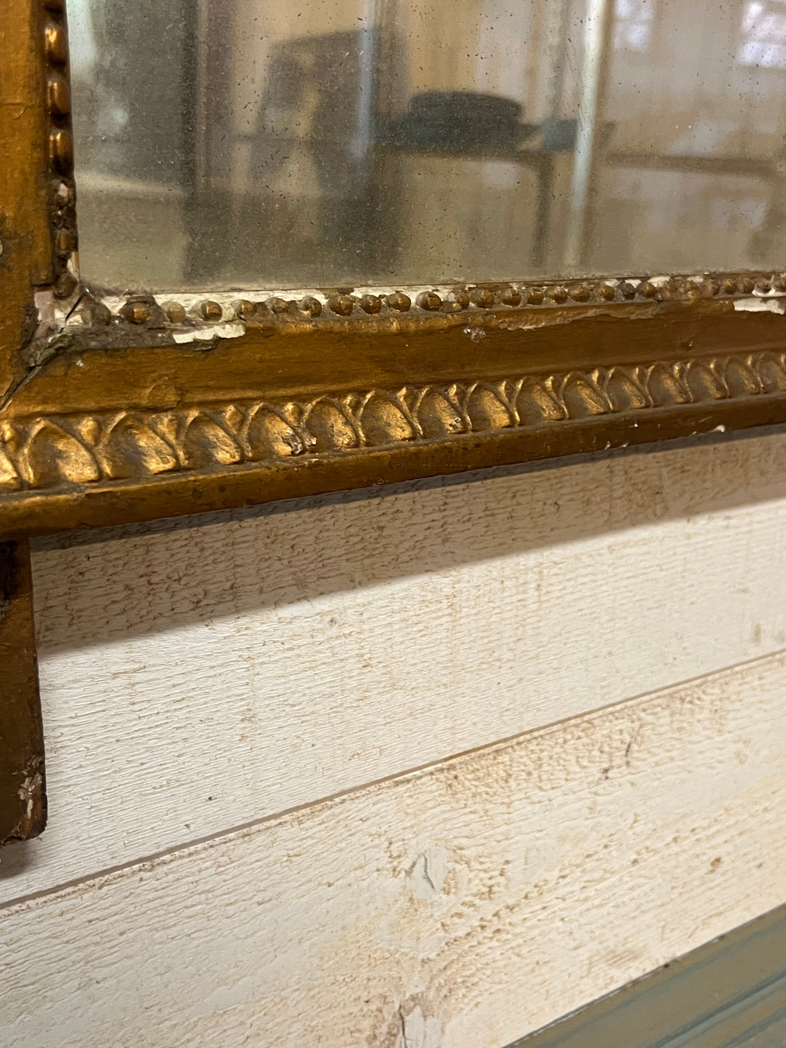 Neoclassical mirror in gilded wood