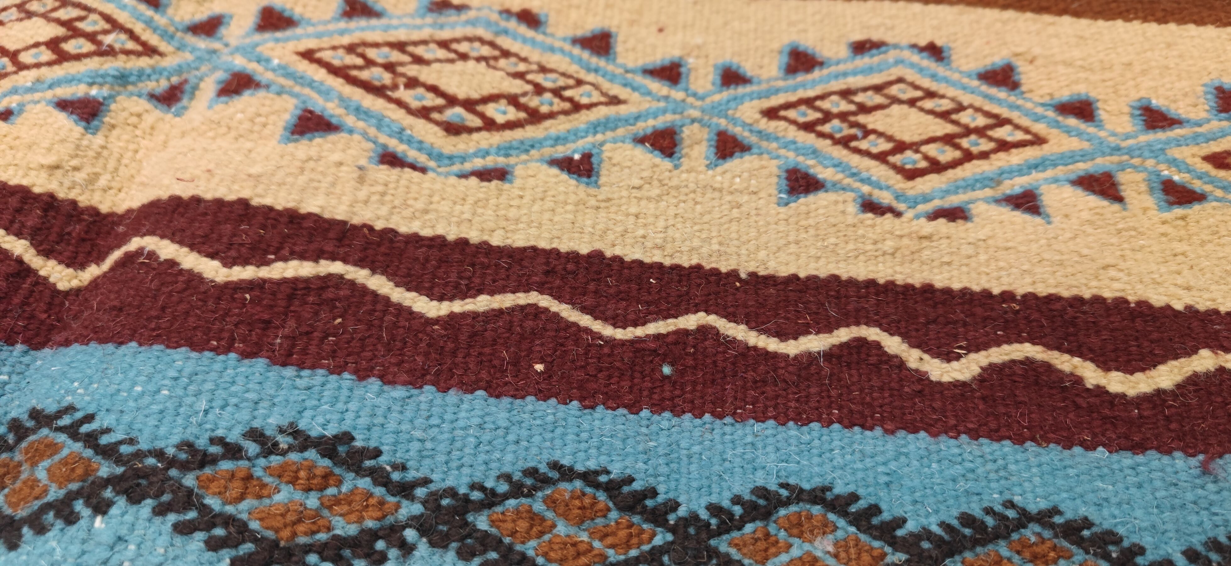 Multicolored hand-woven Berber rugs in natural wool