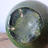 Green old pitcher in glazed terracotta