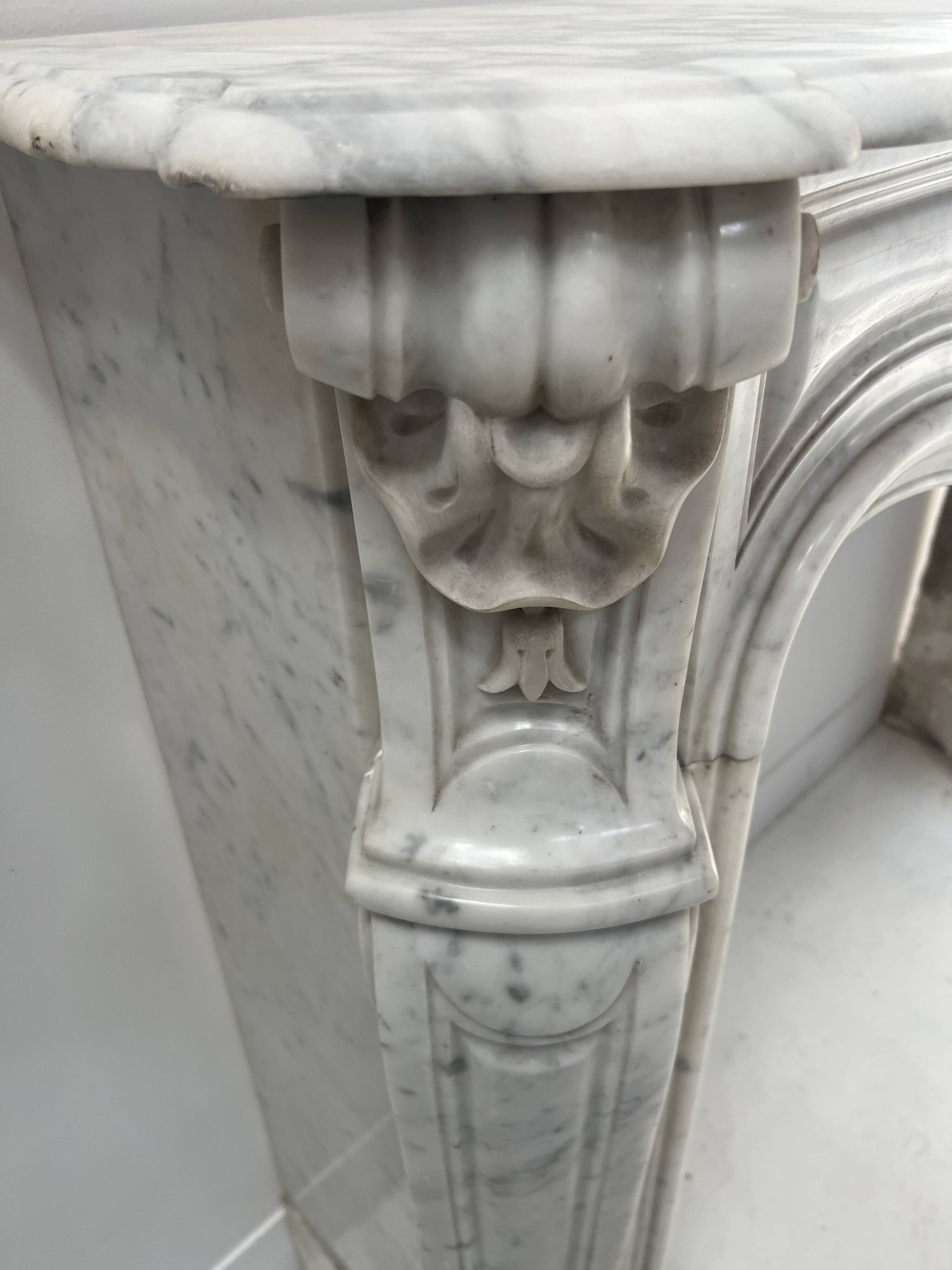 Louis XV style fireplace in veined white Carrara marble, 19th century.