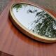 Round mirror of the 50s in gold metal 33cm in diameter