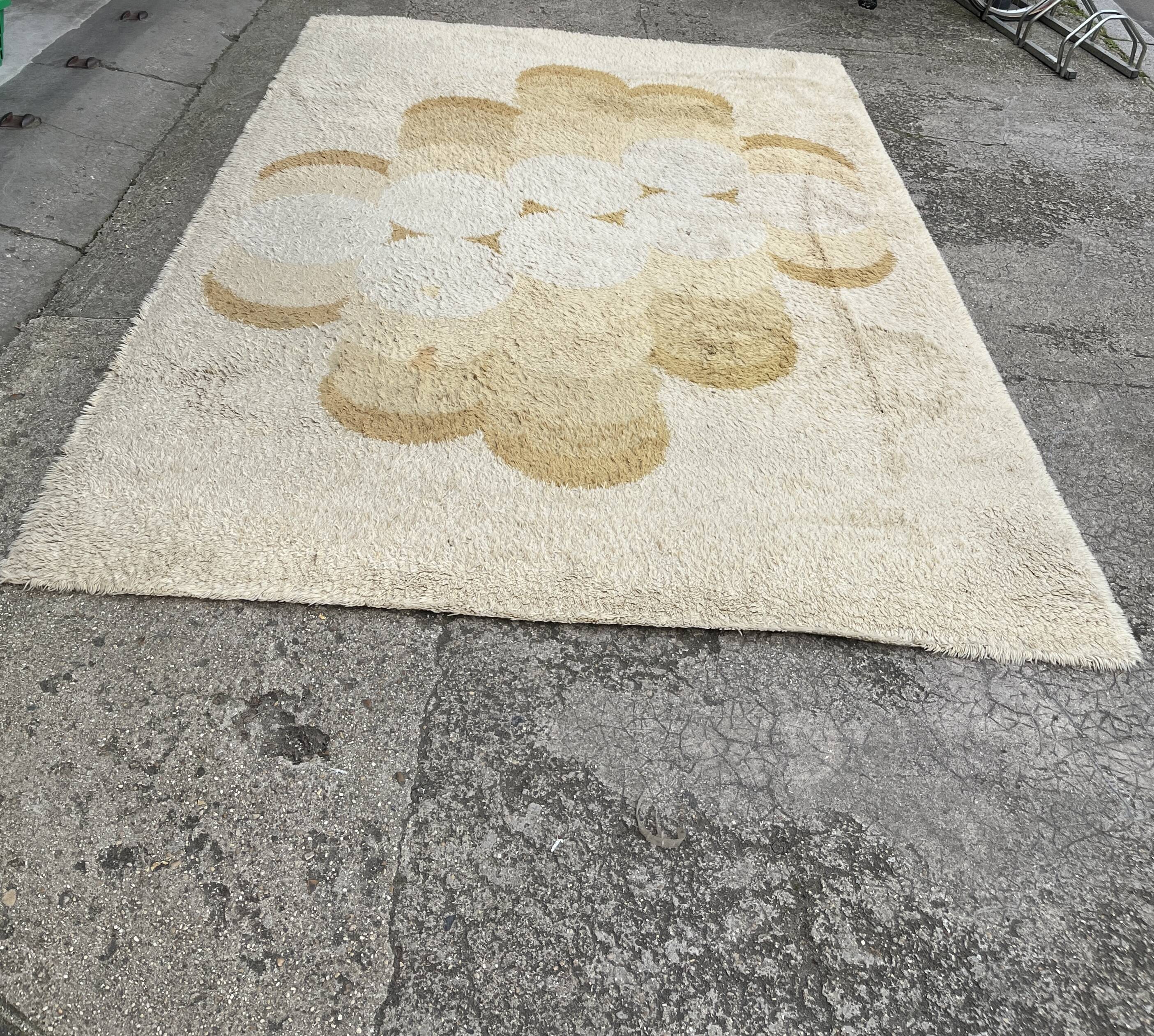 Large rug with floral decoration.
