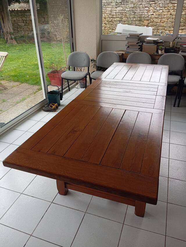 Large rectangular dining table in solid oak in a neo-rustic style.