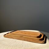 Trio of rounded rectangular trays or cups in monoxyl teak L:35