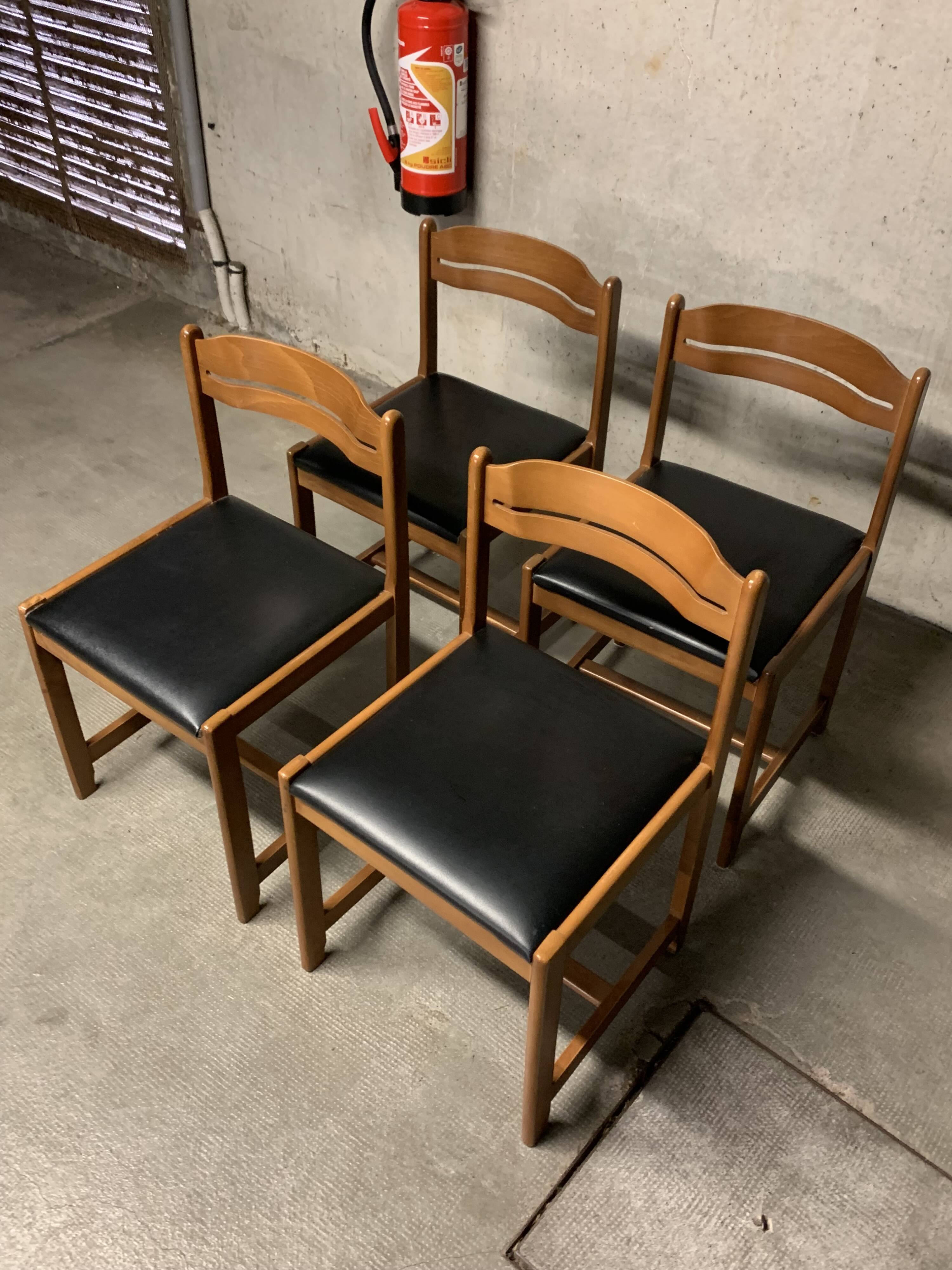 Set of four vintage chairs upholstered in retro design faux leather.