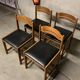 Set of four vintage chairs upholstered in retro design faux leather.