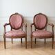 Pair of Louis XVI medallion armchairs in wood and pink fabric.