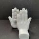 Ceramic bookends in the shape of hands.