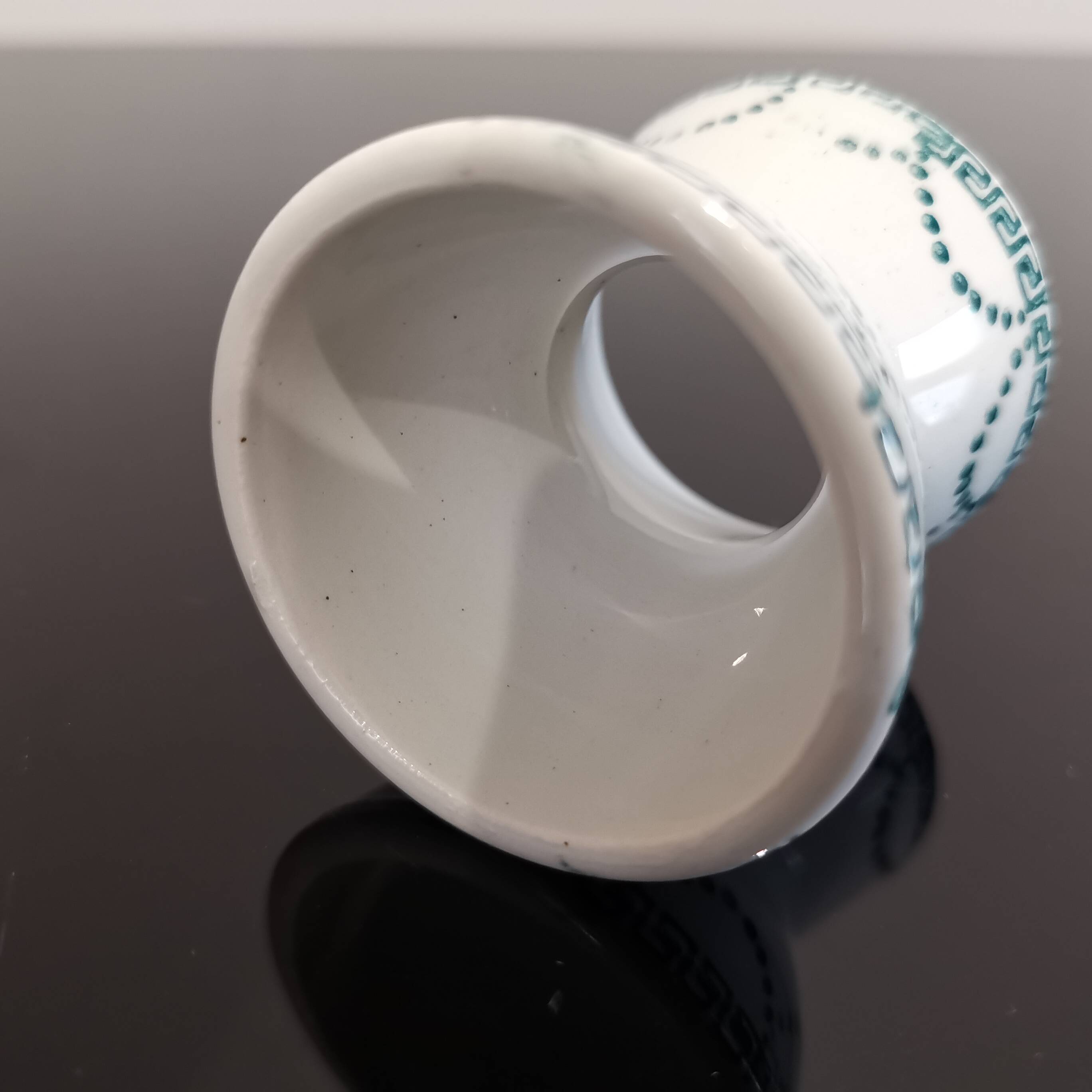 Old porcelain diabolo egg cup decorated with green frieze and garlands