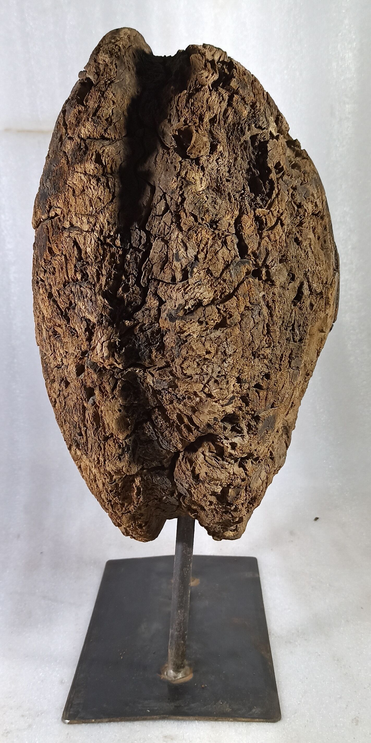 Old wooden pulley wheel on foot