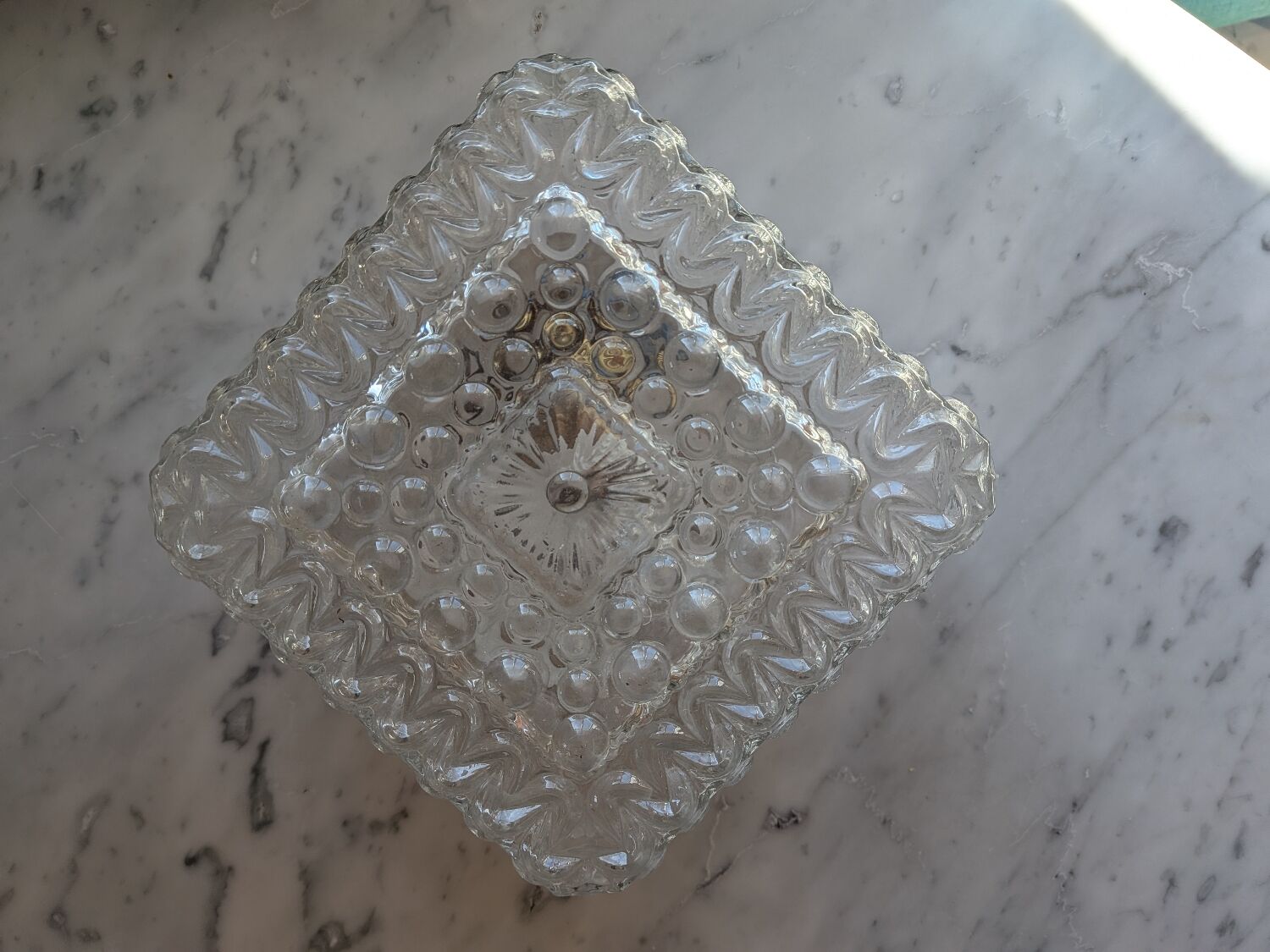 Pressed glass wall light