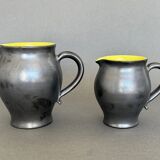 Two pitchers and three Elchinger ceramic bowls black and yellow background 1960