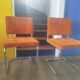 Pair of vintage cantilever chairs in chrome and orange corduroy.