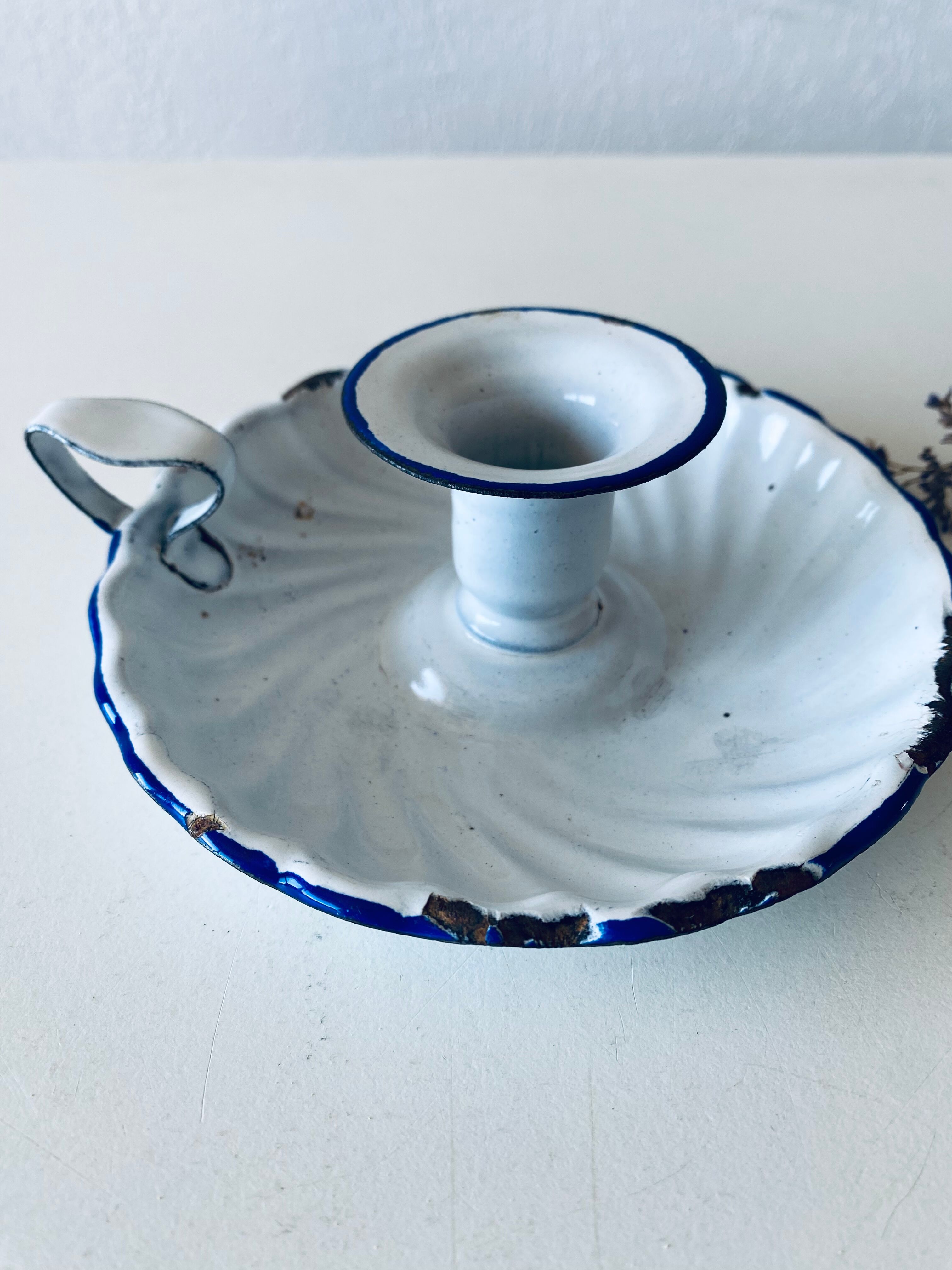 Antique candle holder in white and blue enamelled metal