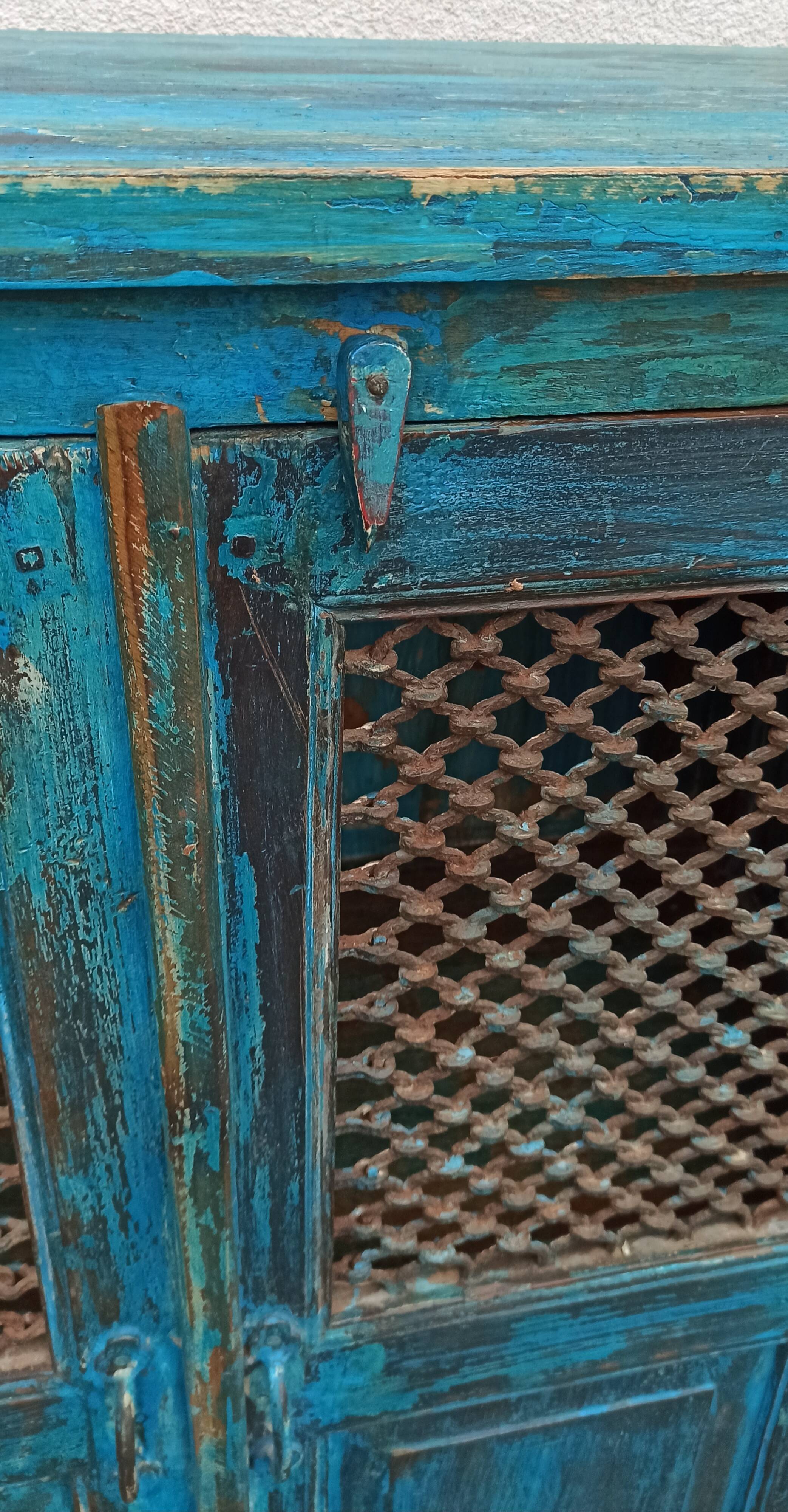 Old wooden cabinet with doors with grille