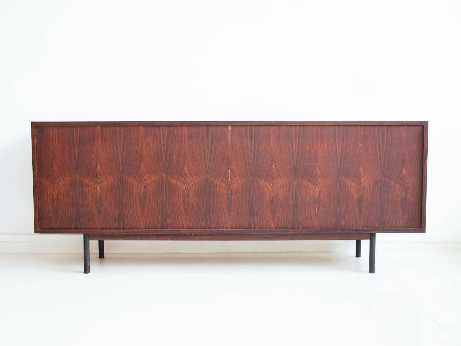 Wooden sideboard with sliding door and white drawers, around 1960.