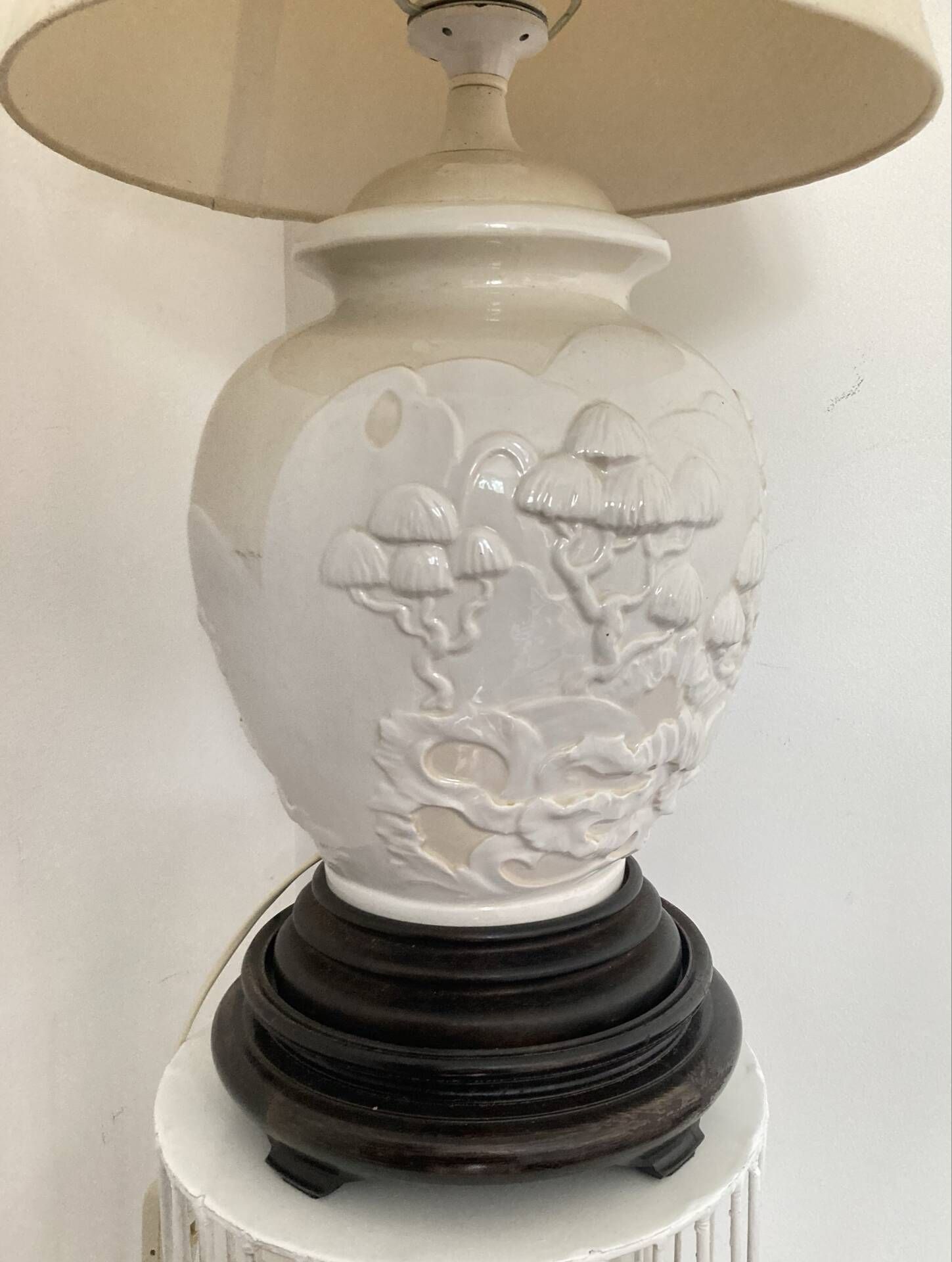 1980s ceramic table lamp with a wooden base and adjustable shade.