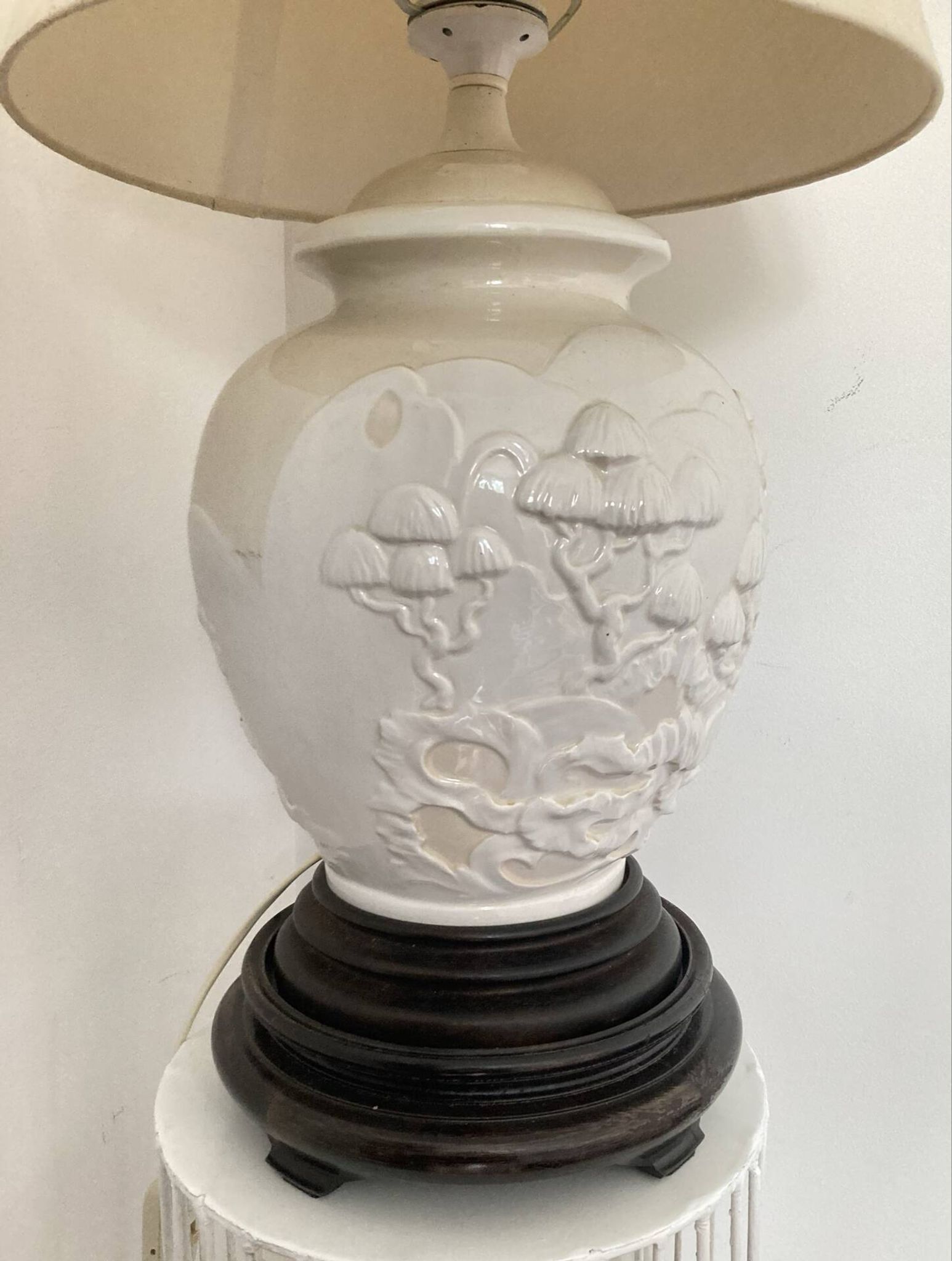 1980s ceramic table lamp with a wooden base and adjustable shade.