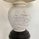 1980s ceramic table lamp with a wooden base and adjustable shade.