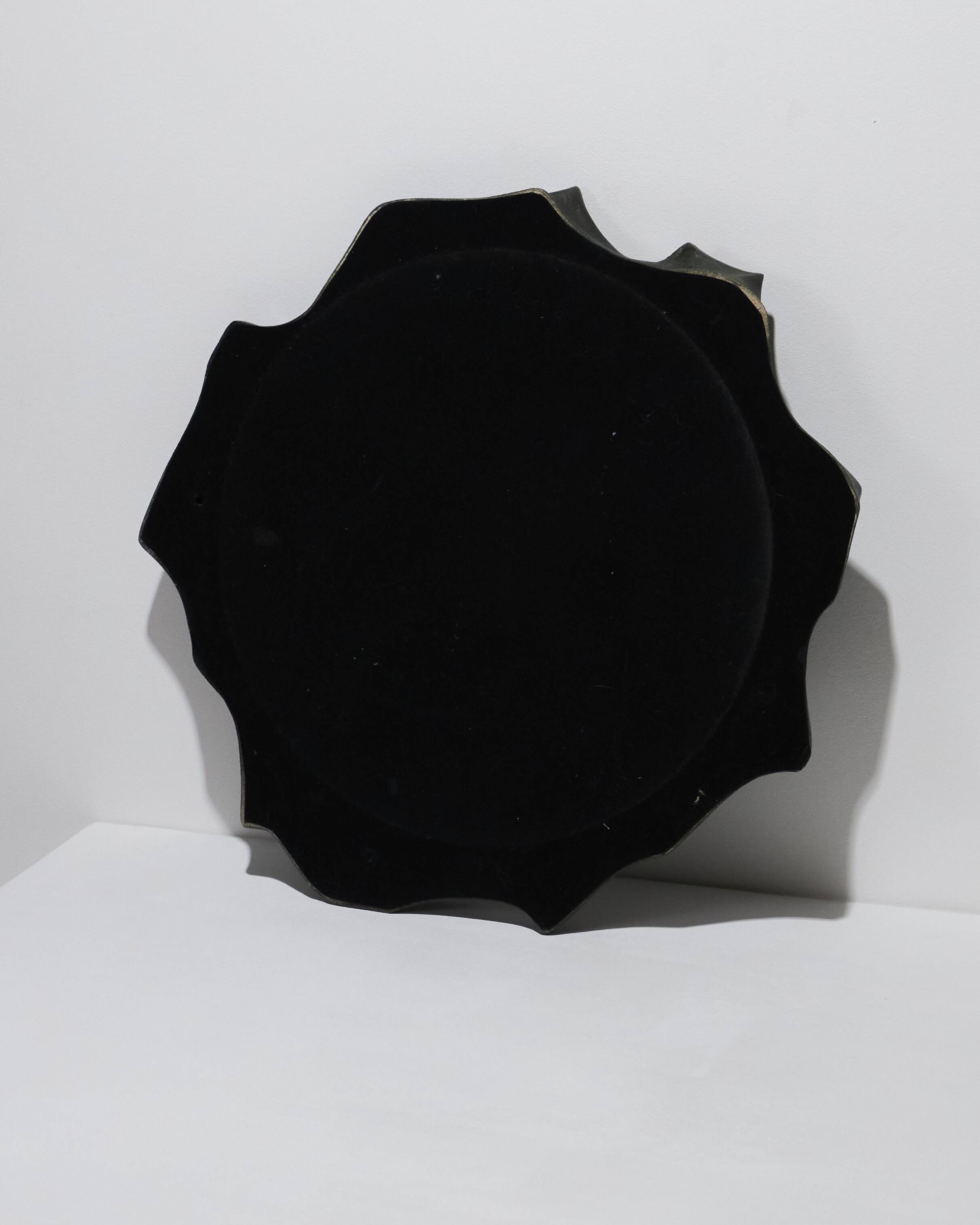 Sculptural sandstone mirror