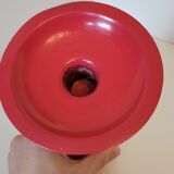 Vintage design candlestick in red metal in the shape of an hourglass