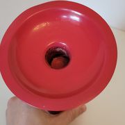 Vintage design candlestick in red metal in the shape of an hourglass