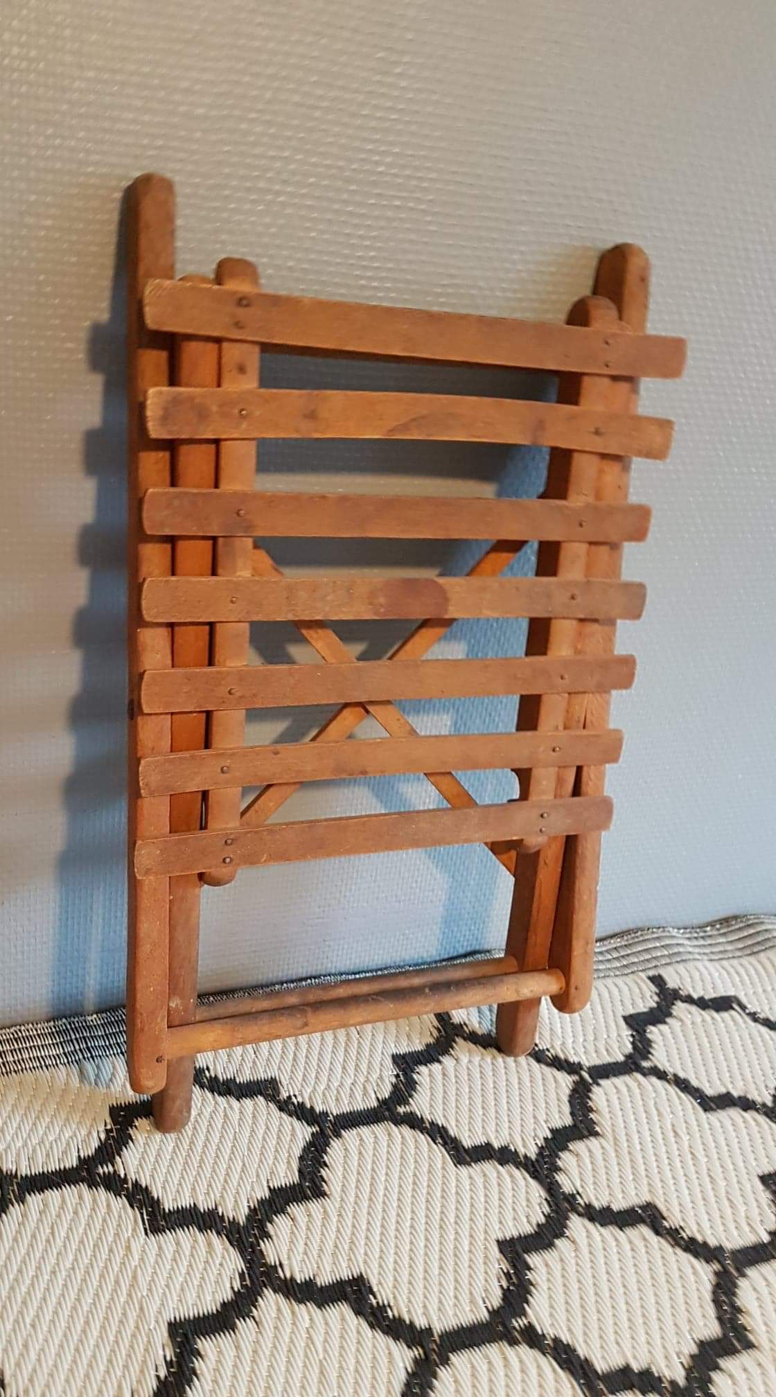 Old foldable stool in tinted wood