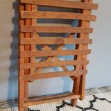 Old foldable stool in tinted wood