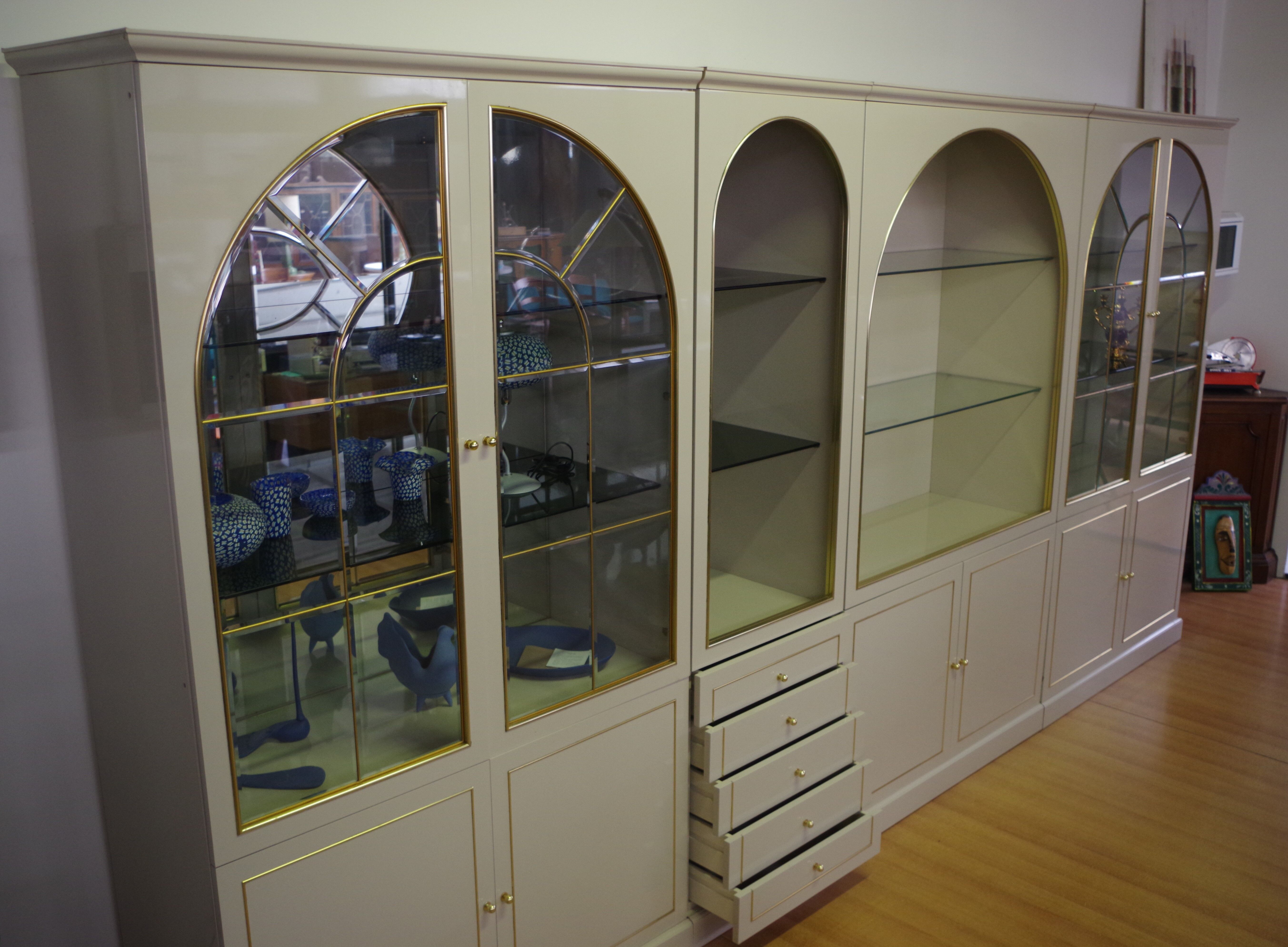 Showcases in lacquered wood, glass and brass  1970s, set of 4