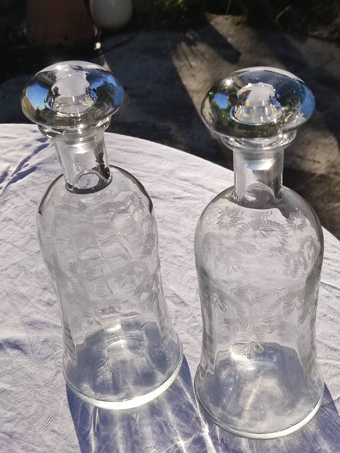 Two antique engraved glass bottles