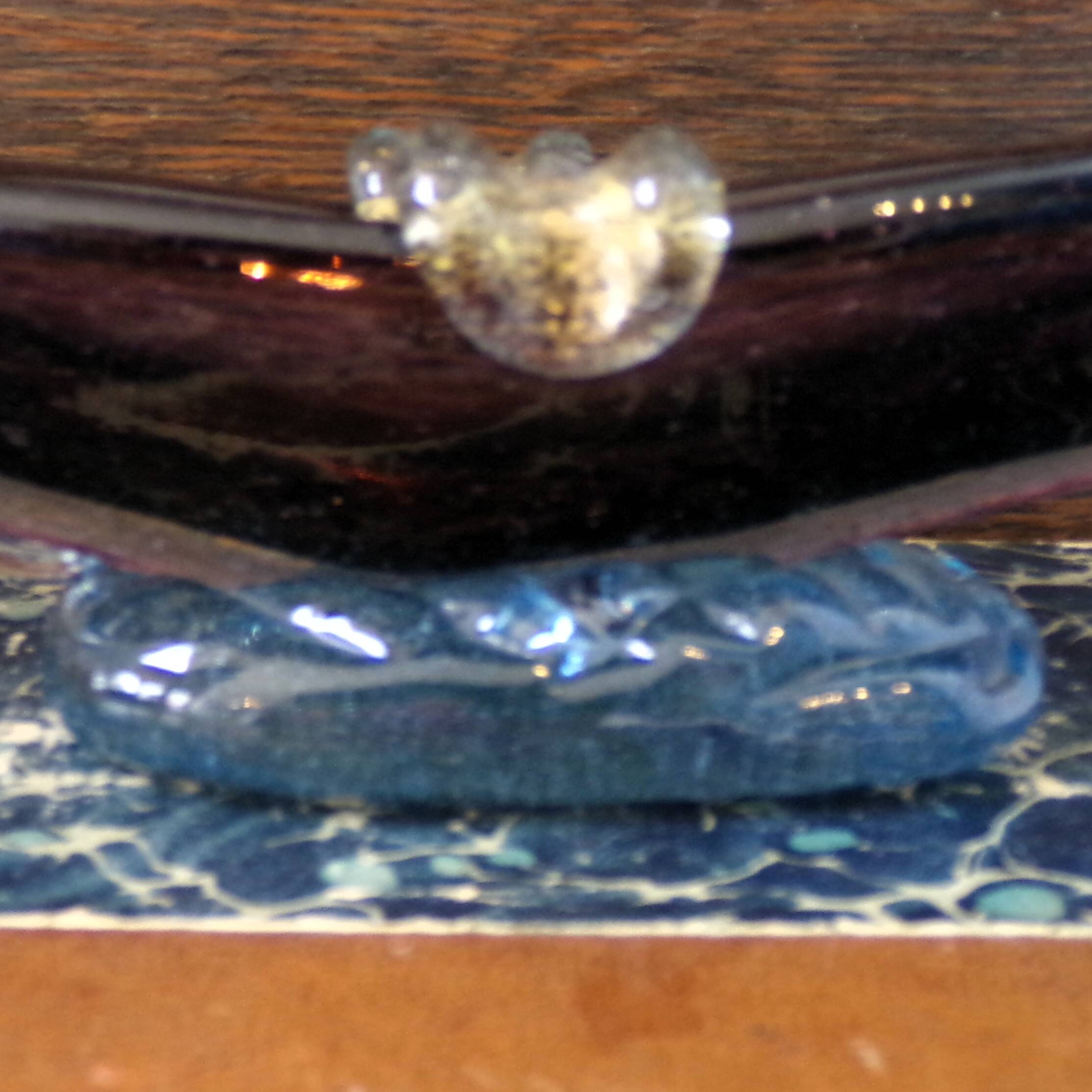 Murano glass gondola placed on a blue water-effect glass base