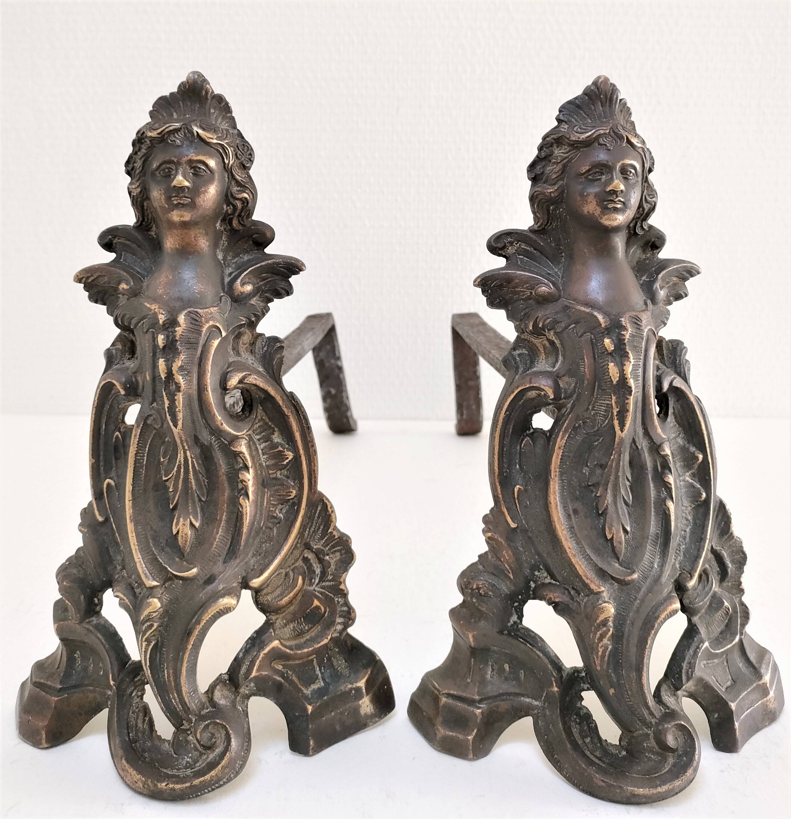 Pair of bronze andirons with black patina, 19th century, female caryatids