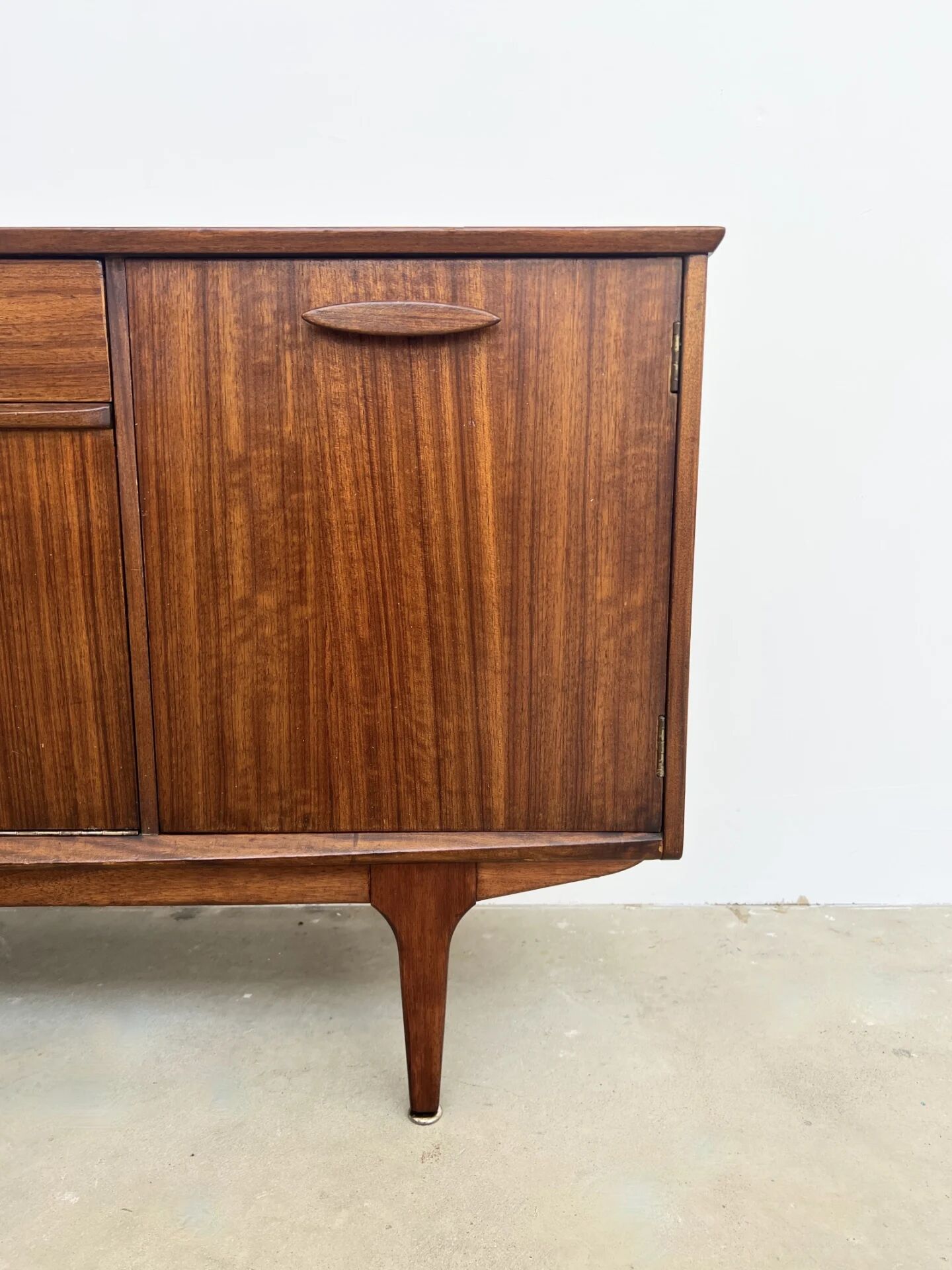 Teak Jentique sideboard — 1 door, 2 drawers & drop-down bar, England 1950s-60s