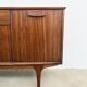 Teak Jentique sideboard — 1 door, 2 drawers & drop-down bar, England 1950s-60s