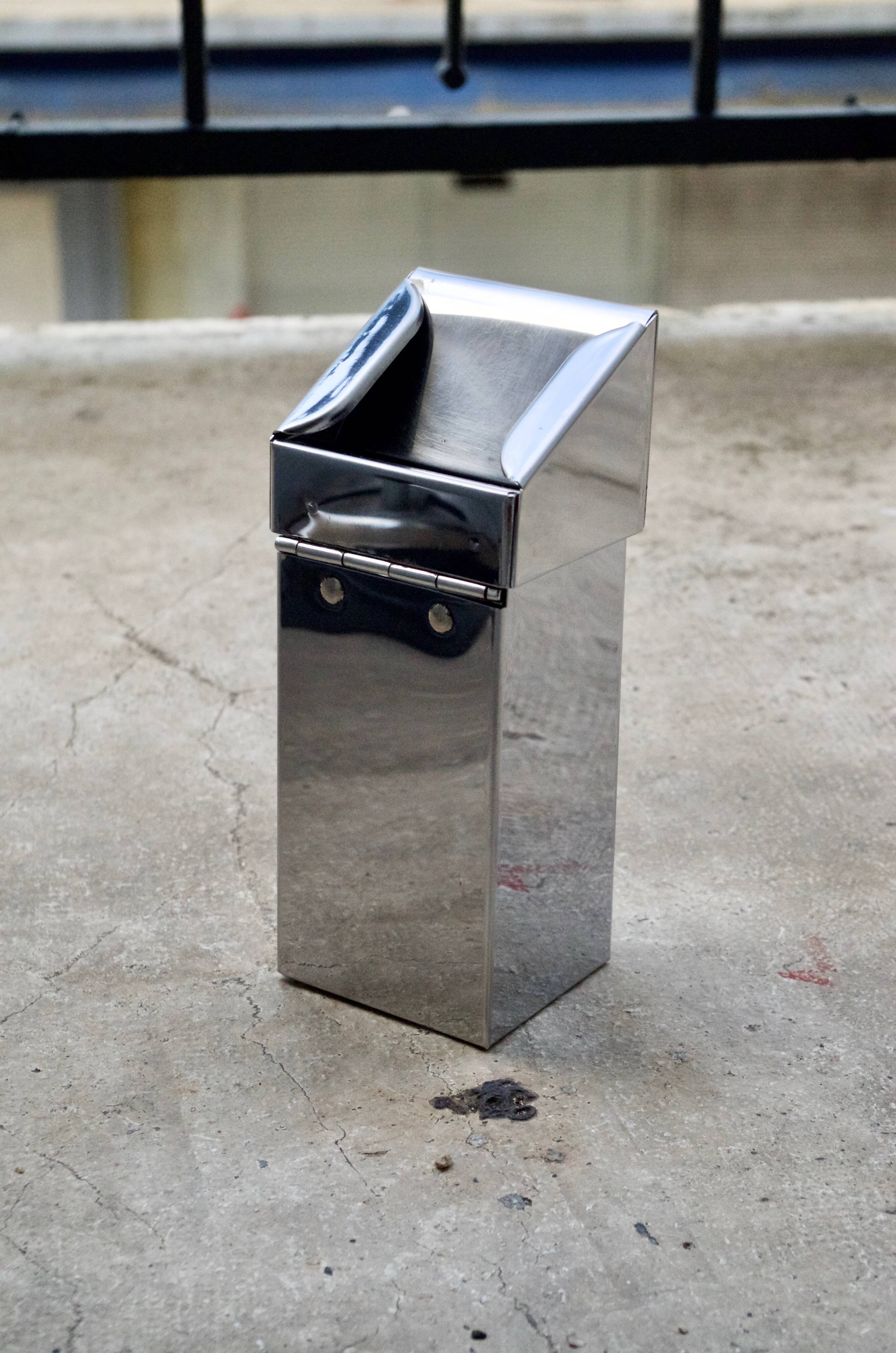 Vintage wall ashtray in shiny metal industrial style
