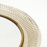 Mid Century Modern round wall mirror with a white expanded metal frame