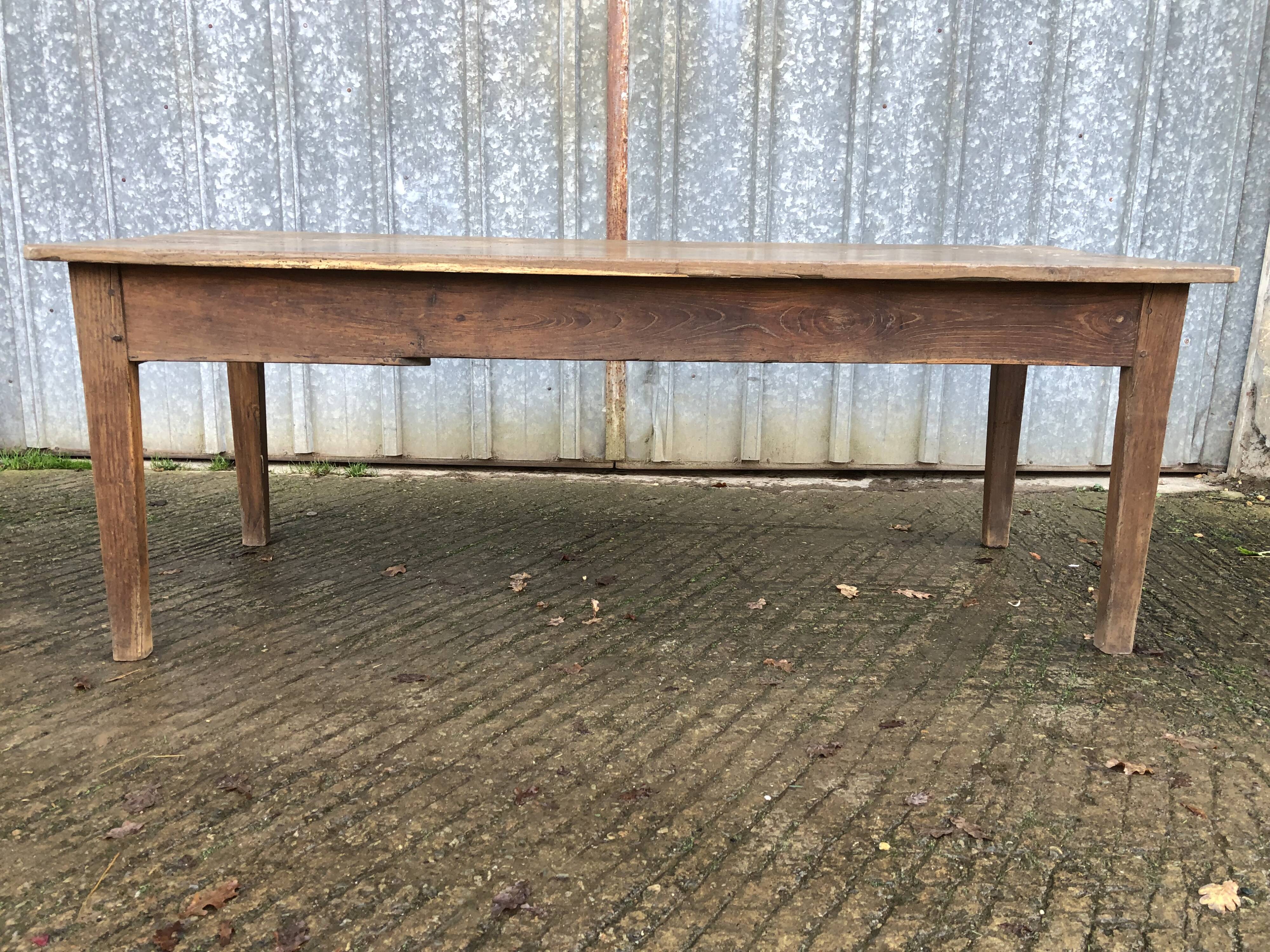 Antique farmhouse table in solid oak with tapered legs and 1 drawer at the end.