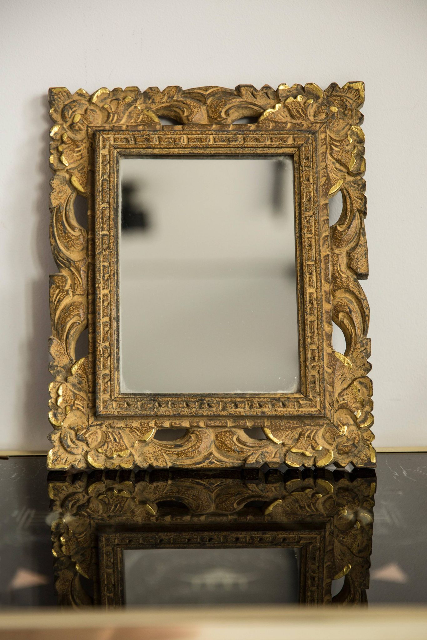 Decorative gold mirror mid-century in a wooden frame, Italy, 1960s.
