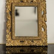 Decorative gold mirror mid-century in a wooden frame, Italy, 1960s.