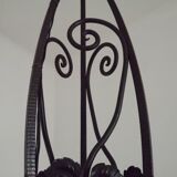 French Art Nouveau leaf detail iron three-light chandelier with amber glass shades.