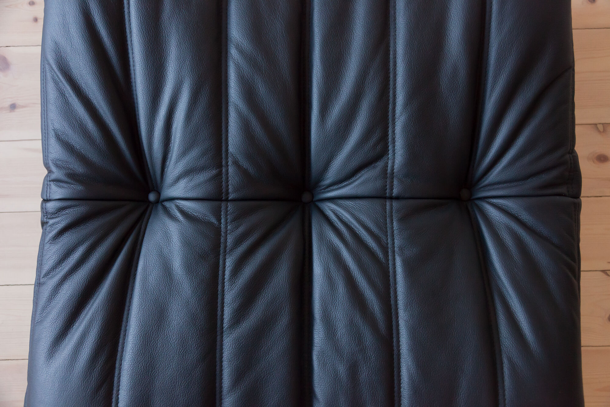 Armchair and ottoman in black leather model designed by Michel Ducaroy 1973
