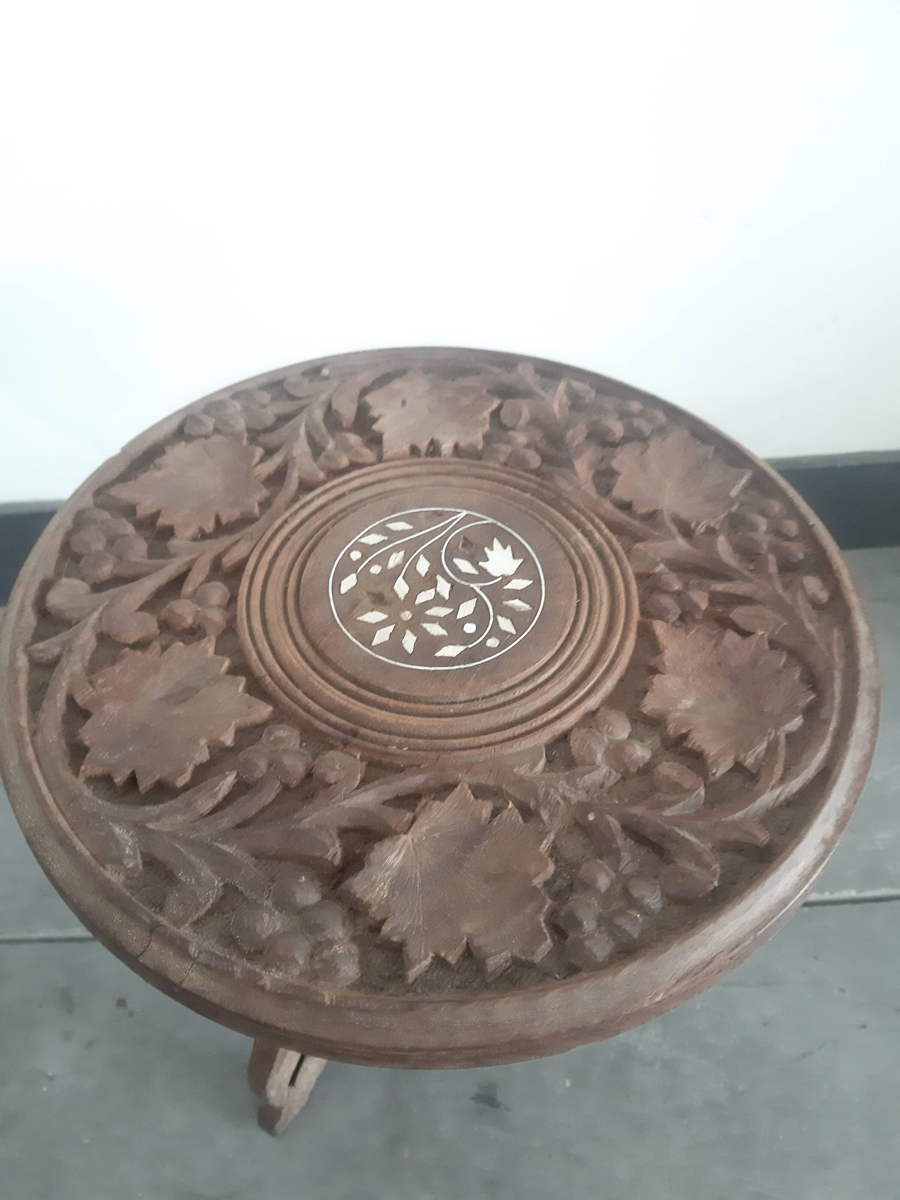 Carved wooden hunting stool decorated with vines