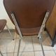 Two brown faux leather chairs.
